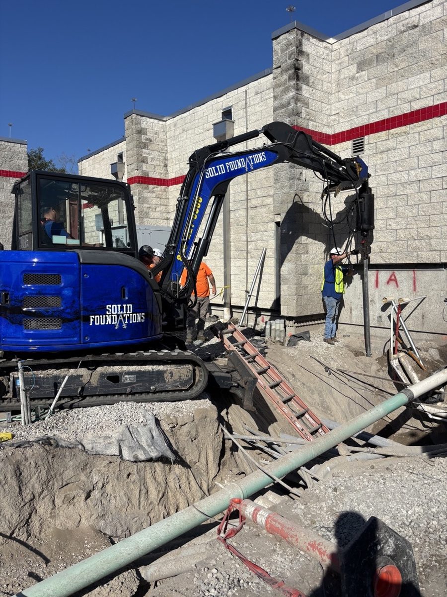 Foundation repair crew working a residential job site