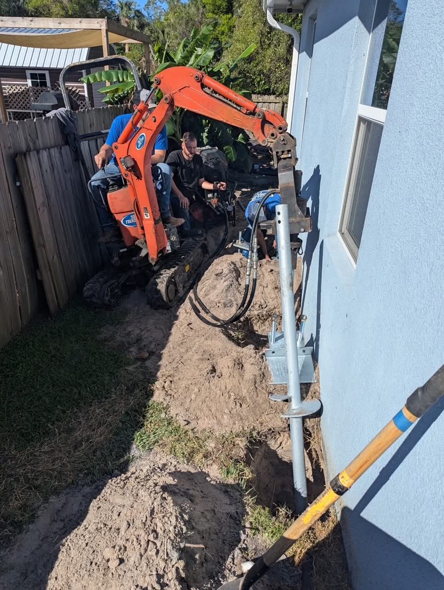 Foundation repair excavation along the side of a home