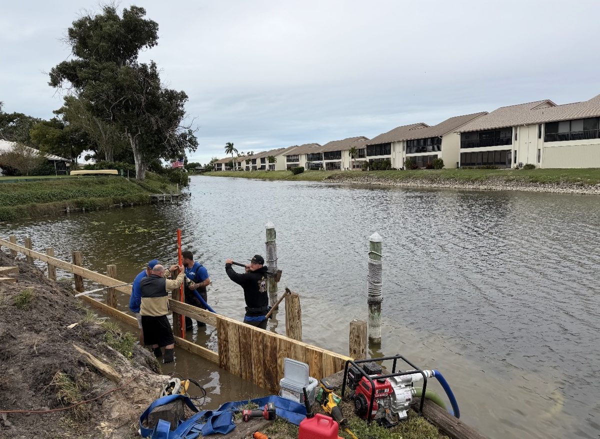 Solid Foundations crew building a new wood seawall along a Florida canal